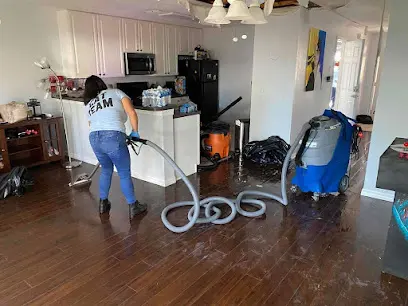 Technician extracting standing water from a floor in Altamonte Springs, FL